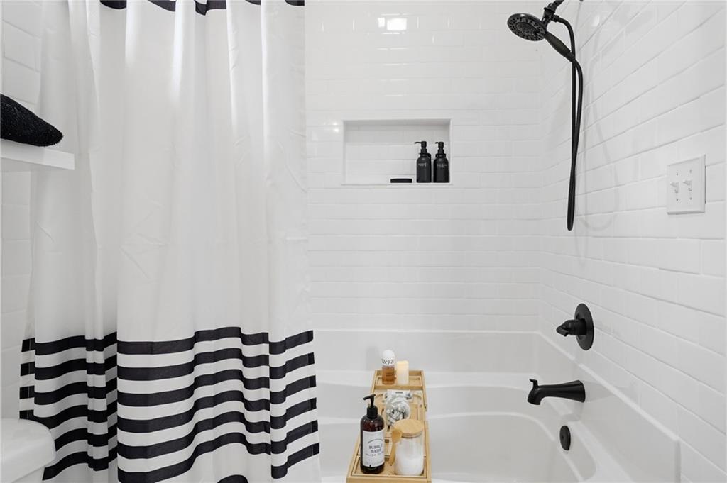 710 Lumber Company Road Talking Rock, GA 30175 - Photo 19 of 27 a bathroom with a bathtub and shower