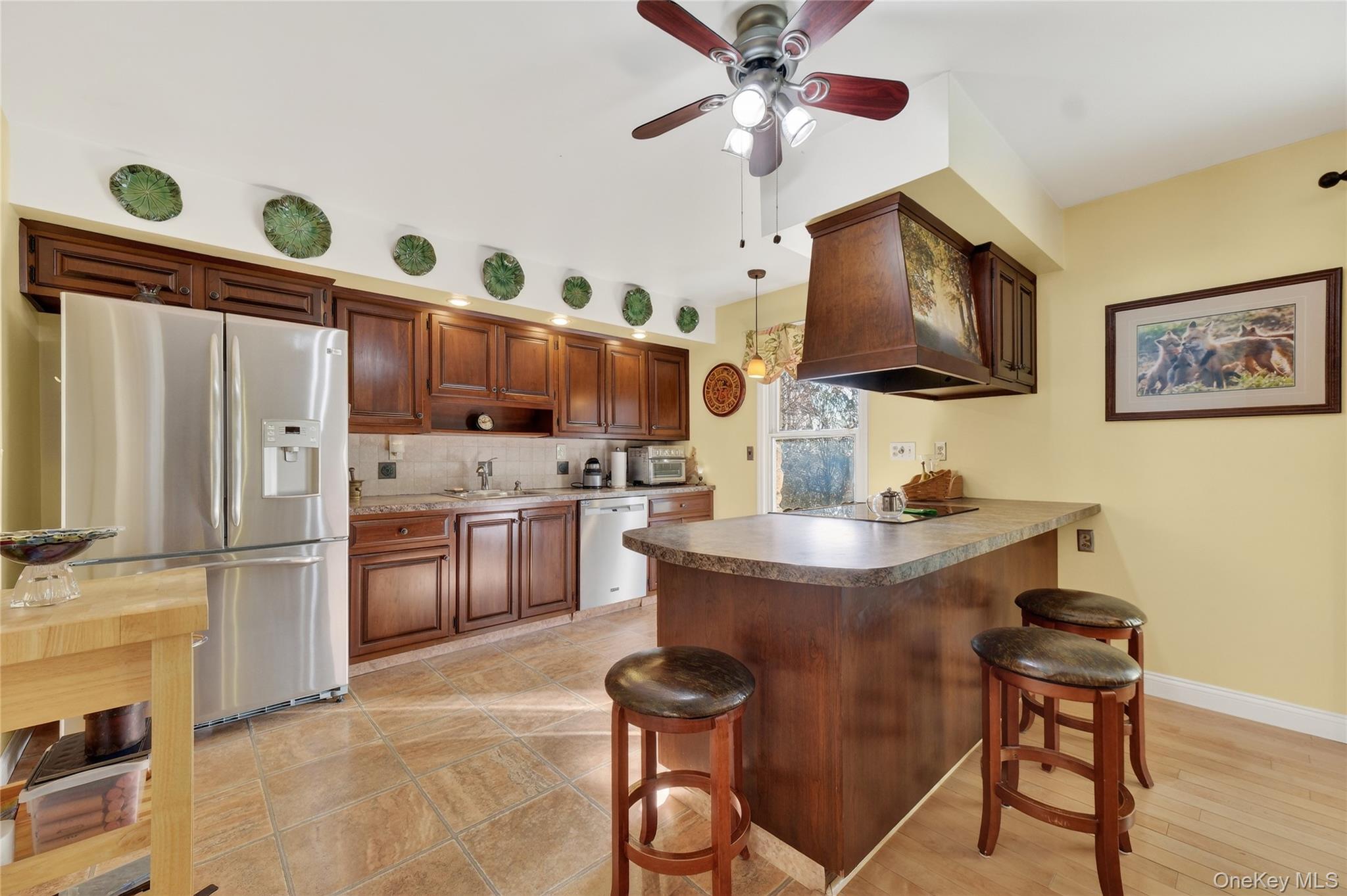 123 Fleury Road Pine Bush, NY 12566 - Photo 12 of 46 Kitchen with a kitchen breakfast bar, a peninsula, stainless steel appliances, backsplash, and ceiling fan