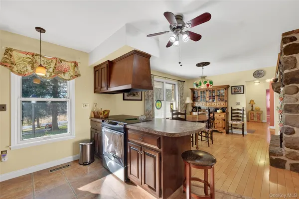 a kitchen with stainless steel appliances granite countertop a sink a stove and a refrigerator