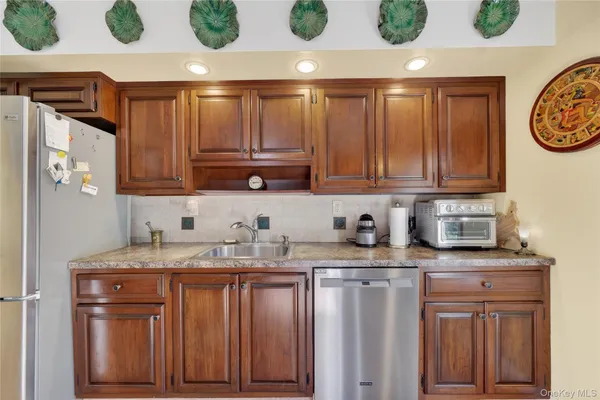 a kitchen with stainless steel appliances granite countertop a refrigerator and stove