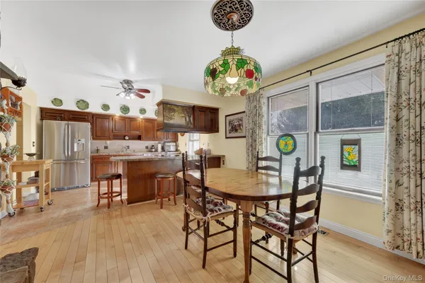 a view of a dining room and kitchen with a table chairs and a chandelier
