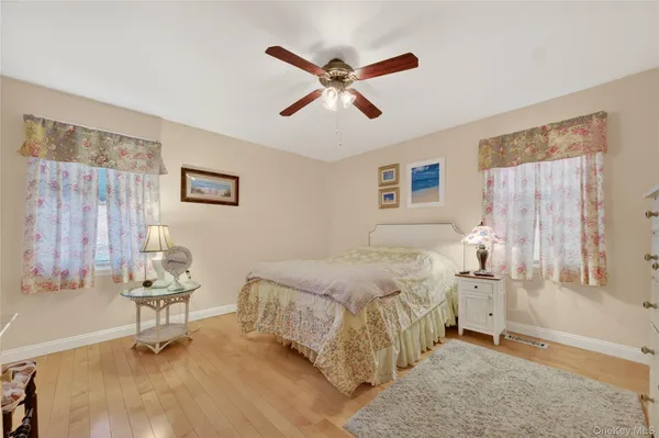 a bedroom with a bed and a flat tv screen on dresser