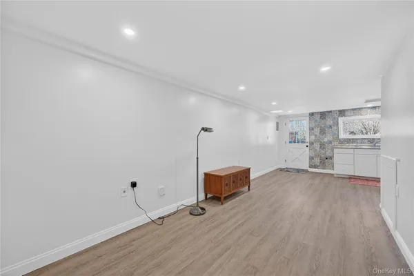 an empty room with wooden floor and closet