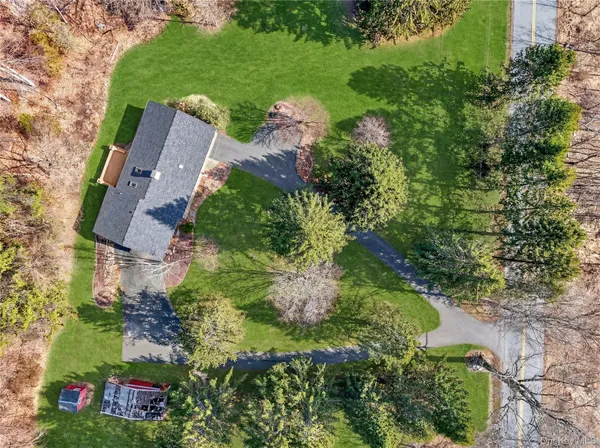 an aerial view of residential house with green space