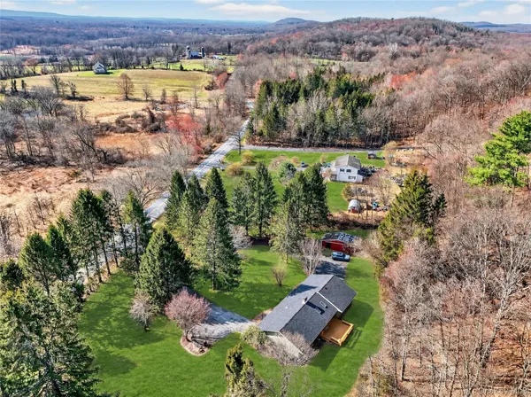 an aerial view of lake residential house with swimming pool and green space