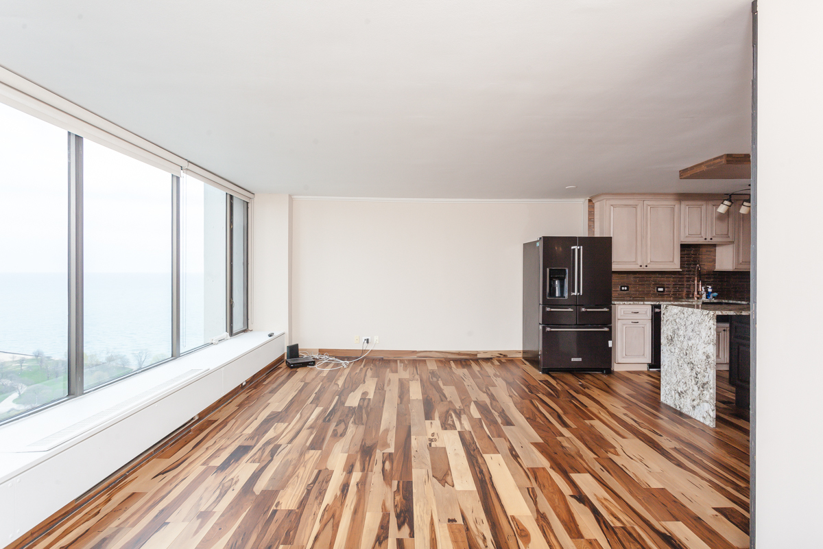 5455 North Sheridan Road, Unit 3307 Chicago, IL 60640 - Photo 13 of 21 a view of kitchen with refrigerator cabinets and wooden floor