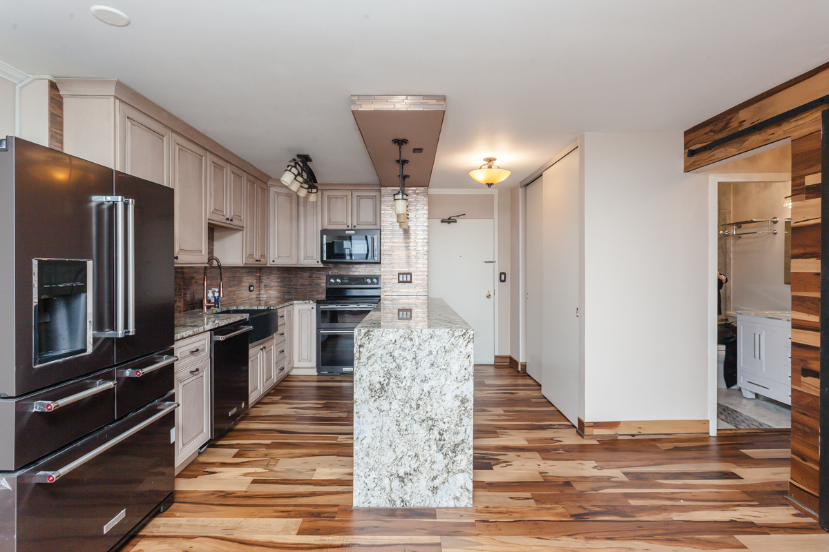 5455 North Sheridan Road, Unit 3307 Chicago, IL 60640 - Photo 4 of 21 a kitchen with stainless steel appliances granite countertop a refrigerator and a stove top oven
