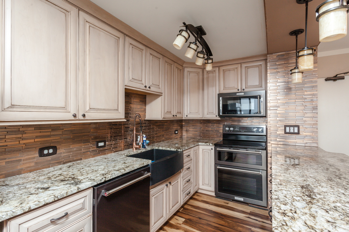 5455 North Sheridan Road, Unit 3307 Chicago, IL 60640 - Photo 5 of 21 a kitchen with stainless steel appliances granite countertop a sink stove and microwave