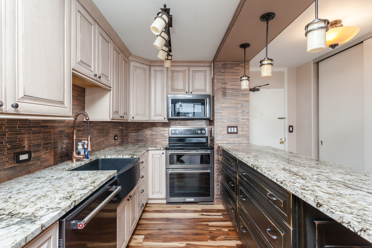 5455 North Sheridan Road, Unit 3307 Chicago, IL 60640 - Photo 6 of 21 a kitchen with stainless steel appliances granite countertop a stove and cabinets