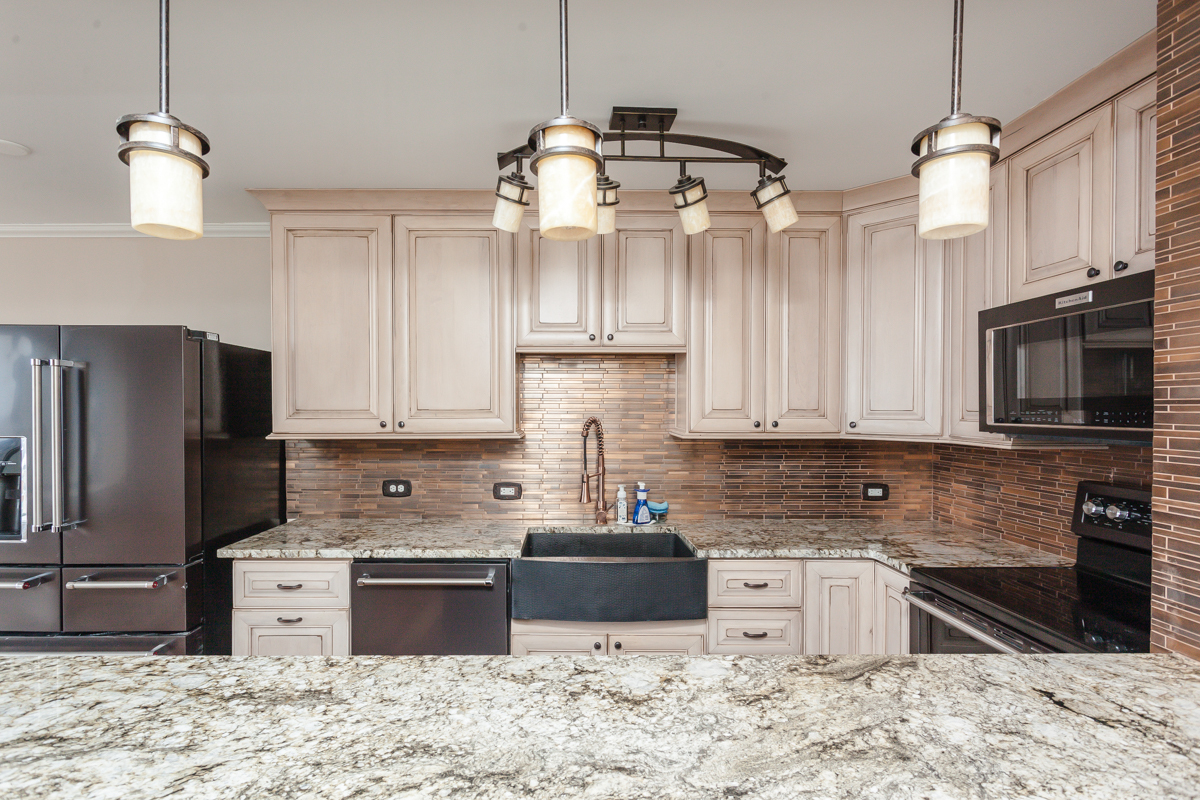 5455 North Sheridan Road, Unit 3307 Chicago, IL 60640 - Photo 8 of 21 a kitchen with stainless steel appliances granite countertop a sink refrigerator stove and microwave