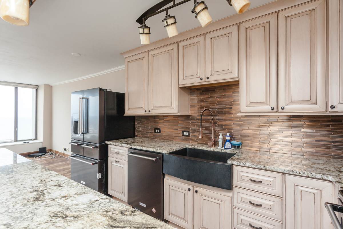 5455 North Sheridan Road, Unit 3307 Chicago, IL 60640 - Photo 9 of 21 a kitchen with stainless steel appliances granite countertop a sink stove and refrigerator