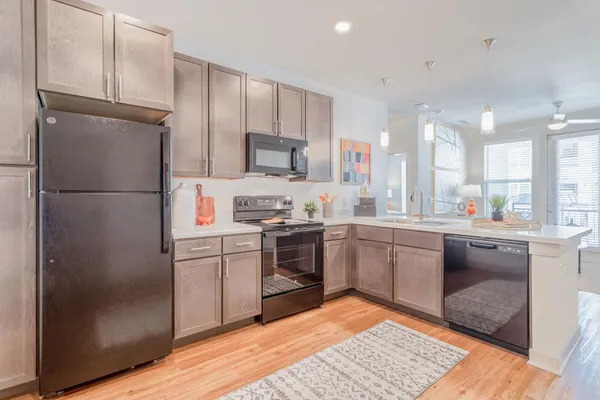 a kitchen with a refrigerator sink and microwave