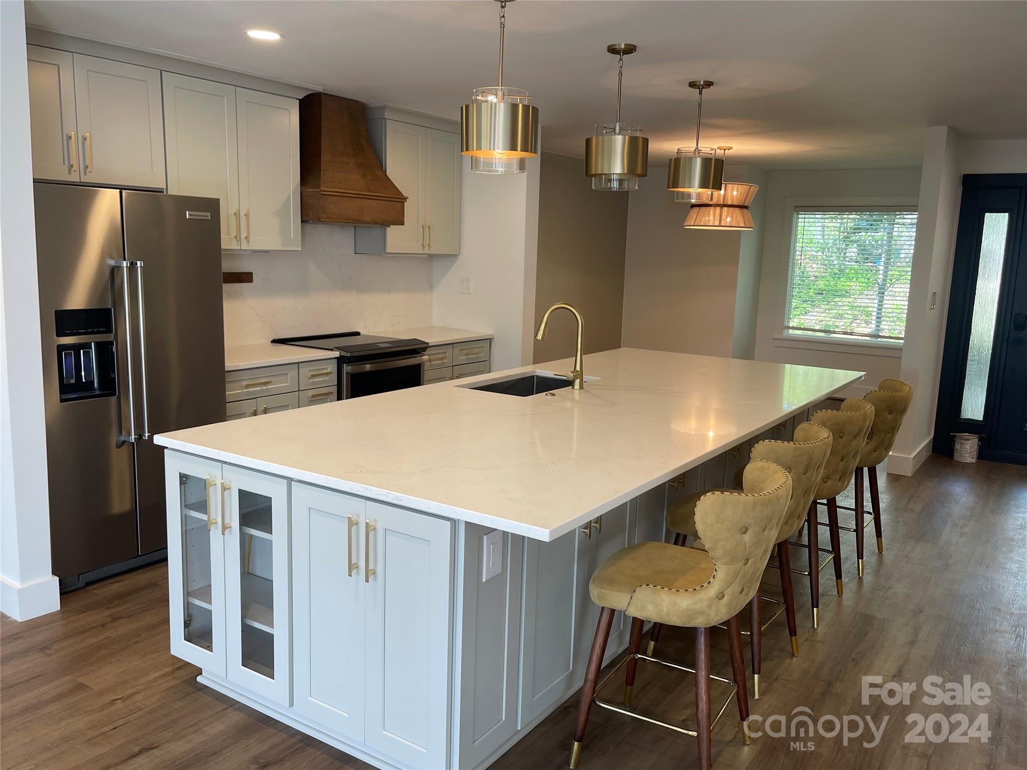 63 Ridgeport Road Clover, SC 29710 - Photo 2 of 7 a kitchen with stainless steel appliances a table chairs and wooden floor