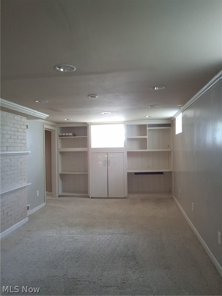236 Bowland Road Mansfield, OH 44907 - Photo 19 of 34 Carpeted interior space featuring recessed lighting, extensive built-in shelving, a built-in cabinet, and a white brick-finish wall detail