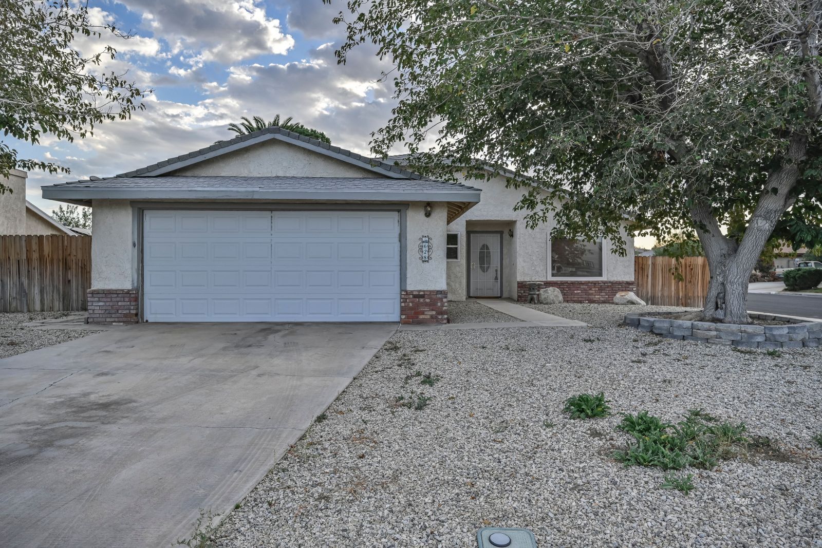 628 South Gemstone Street Ridgecrest, CA 93555 - Photo 1 of 24 a front view of a house with a yard and garage