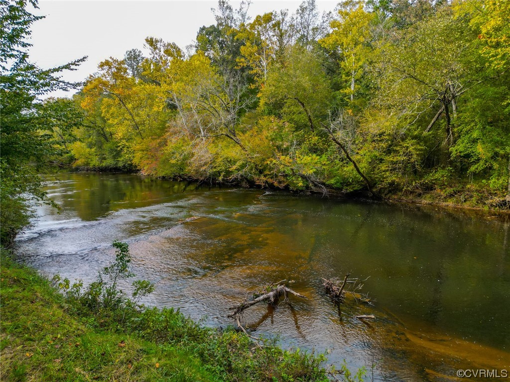 14440 Yankeetown Road Ashland, VA 23005 - Photo 11 of 50 a view of a lake with a yard and trees all around