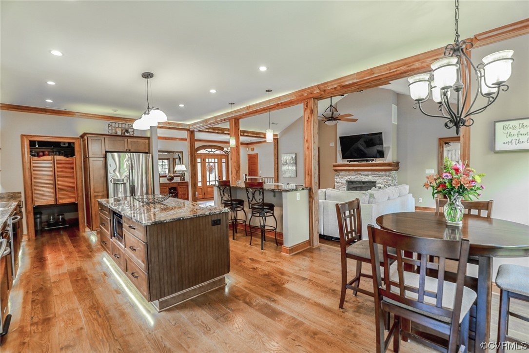 14440 Yankeetown Road Ashland, VA 23005 - Photo 22 of 50 a kitchen with stainless steel appliances granite countertop table chairs and a wooden floor
