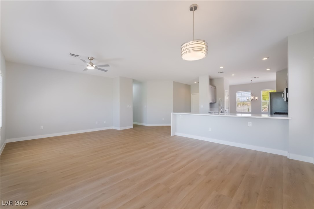 1442 Fieldbrook Street Henderson, NV 89052 - Photo 14 of 36 Unfurnished living room featuring light wood-type flooring, ceiling fan, and recessed lighting