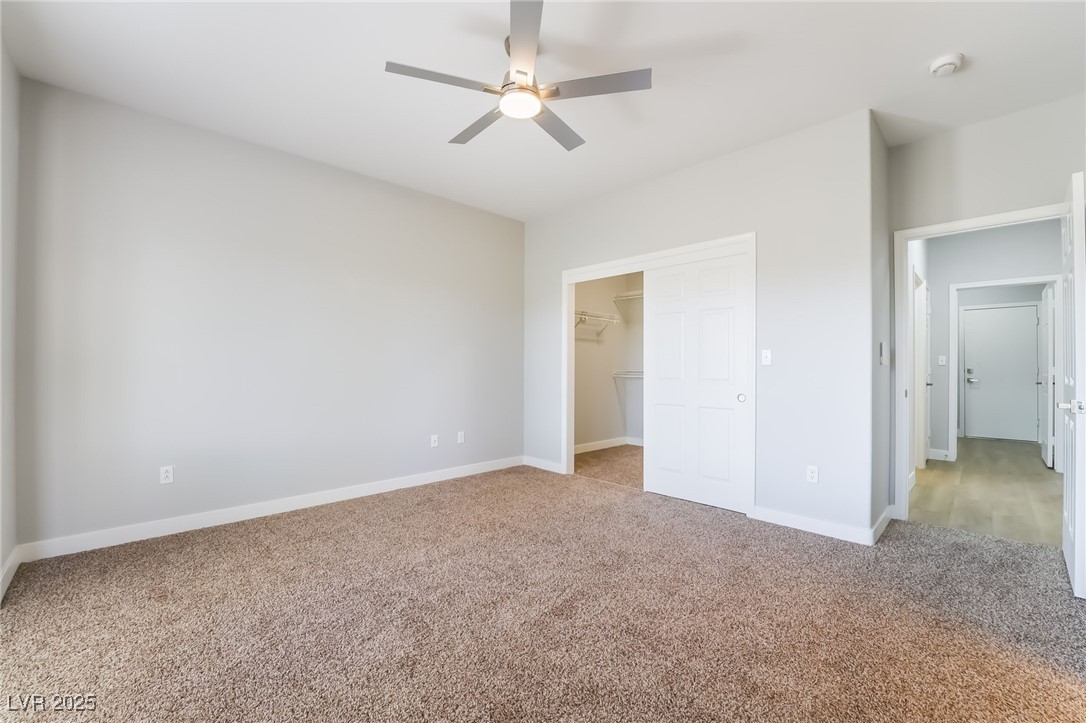 1442 Fieldbrook Street Henderson, NV 89052 - Photo 24 of 36 Unfurnished bedroom featuring carpet floors, a spacious closet, and a ceiling fan
