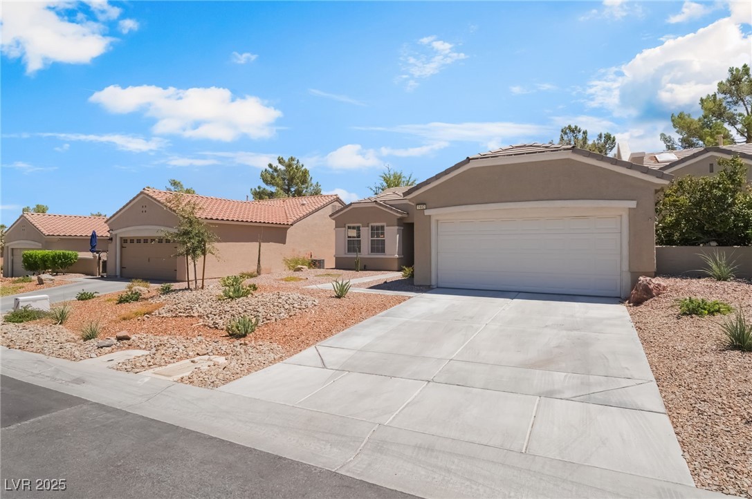 1442 Fieldbrook Street Henderson, NV 89052 - Photo 3 of 36 Single story home featuring stucco siding, an attached garage, driveway, and a tile roof