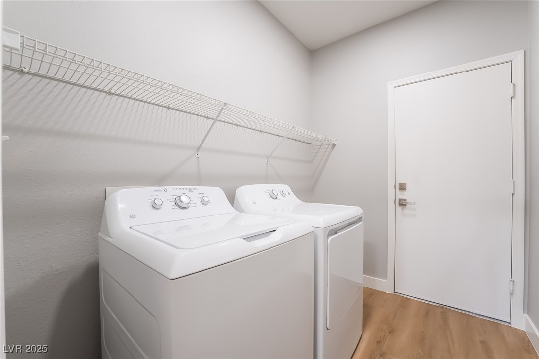 1442 Fieldbrook Street Henderson, NV 89052 - Photo 32 of 36 Laundry room with light wood-type flooring and separate washer and dryer