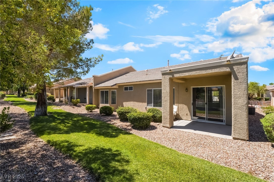 1442 Fieldbrook Street Henderson, NV 89052 - Photo 33 of 36 Rear view of property with stucco siding, a patio, and a yard