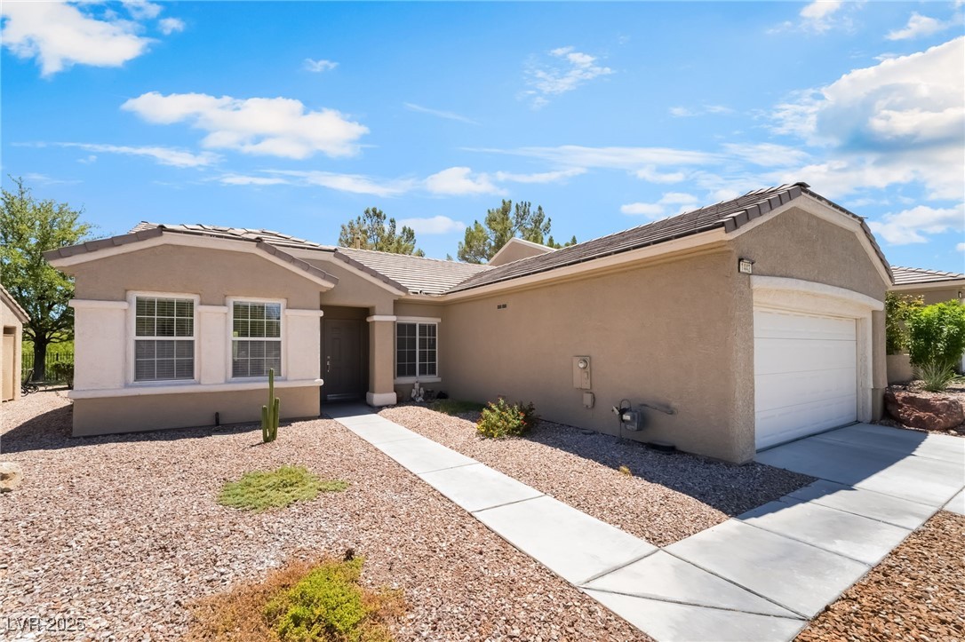 1442 Fieldbrook Street Henderson, NV 89052 - Photo 5 of 36 Ranch-style house featuring a tile roof, stucco siding, an attached garage, and driveway
