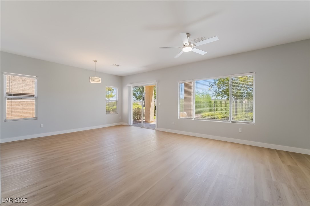1442 Fieldbrook Street Henderson, NV 89052 - Photo 8 of 36 Empty room with light wood-type flooring and ceiling fan