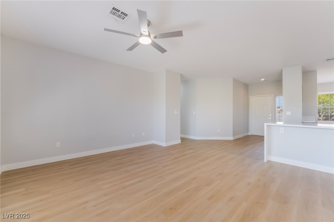 1442 Fieldbrook Street Henderson, NV 89052 - Photo 10 of 36 Unfurnished living room with light wood-style flooring and a ceiling fan