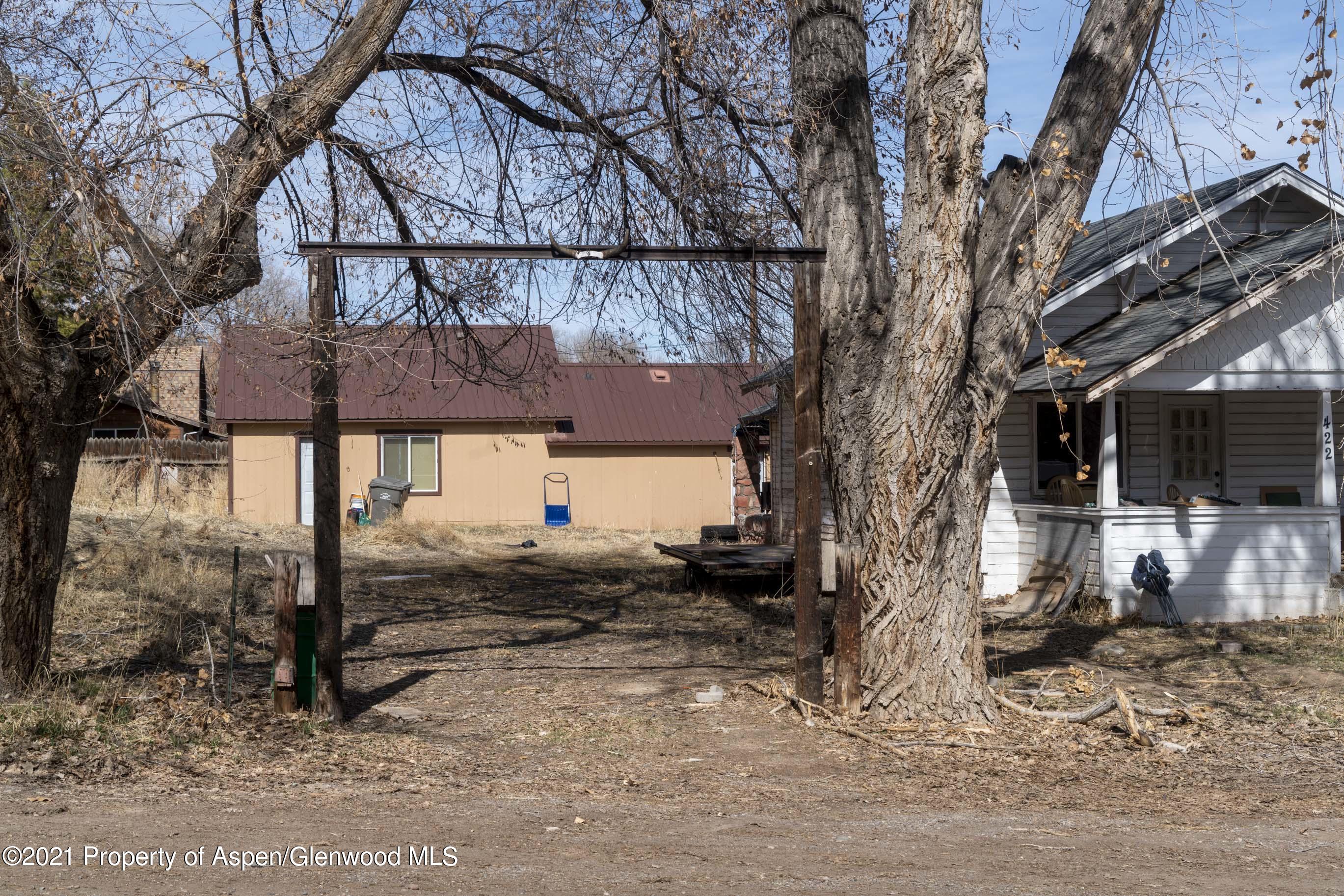 a view of a house with a tree back yard