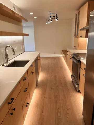 a kitchen with sink and refrigerator