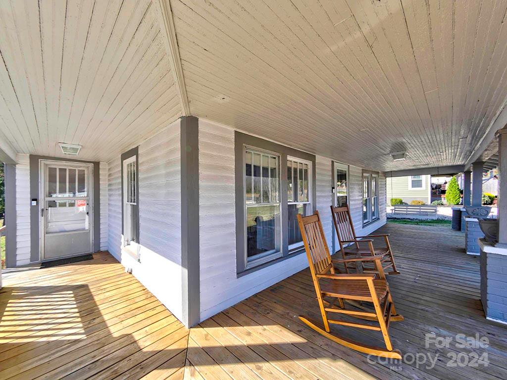 508 South Main Street Troutman, NC 28166 - Photo 2 of 38 a view of a patio with table and chairs with wooden floor and fence