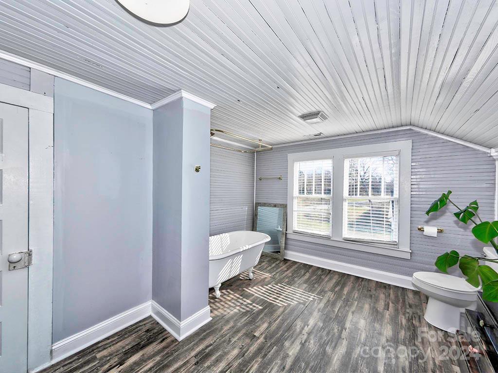 508 South Main Street Troutman, NC 28166 - Photo 26 of 38 a spacious bathroom with a granite countertop toilet a sink and a window