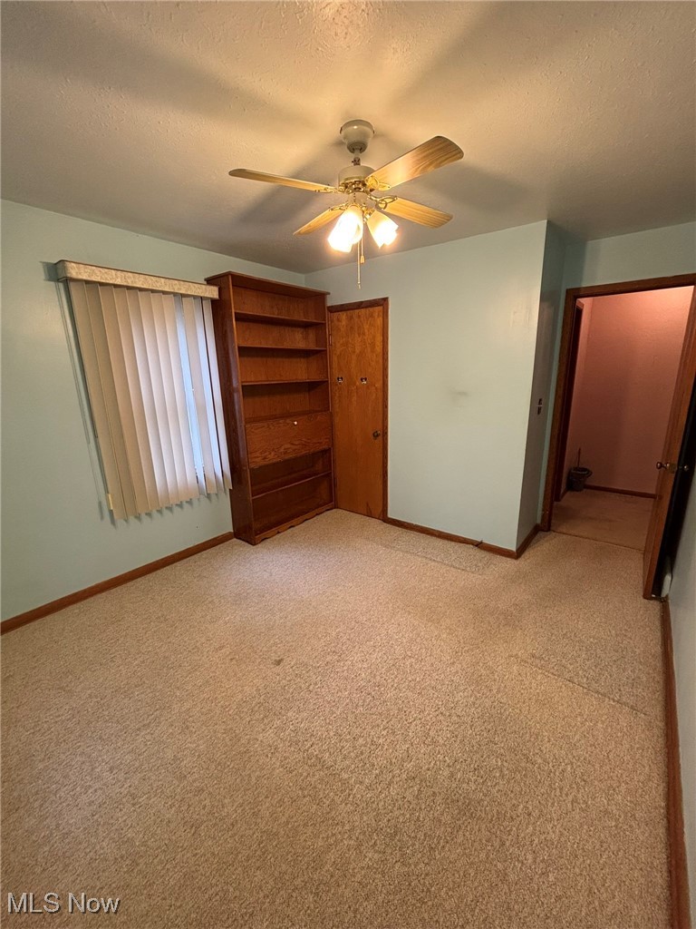 1039 Center Road Eastlake, OH 44095 - Photo 17 of 29 Second bedroom featuring ceiling fan and built-in shelving.