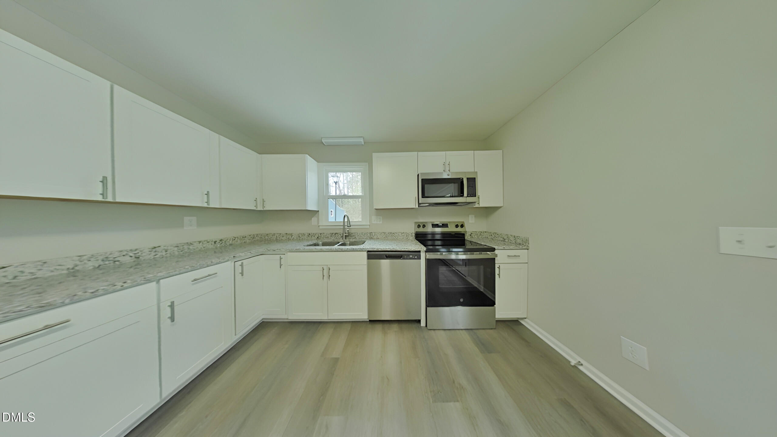 43 Redbud Court Durham, NC 27713 - Photo 4 of 15 a kitchen with granite countertop white cabinets and stainless steel appliances
