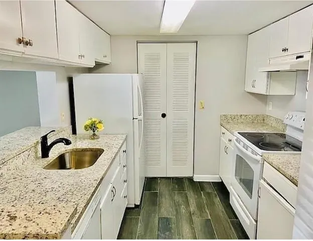 a kitchen with a sink and a refrigerator