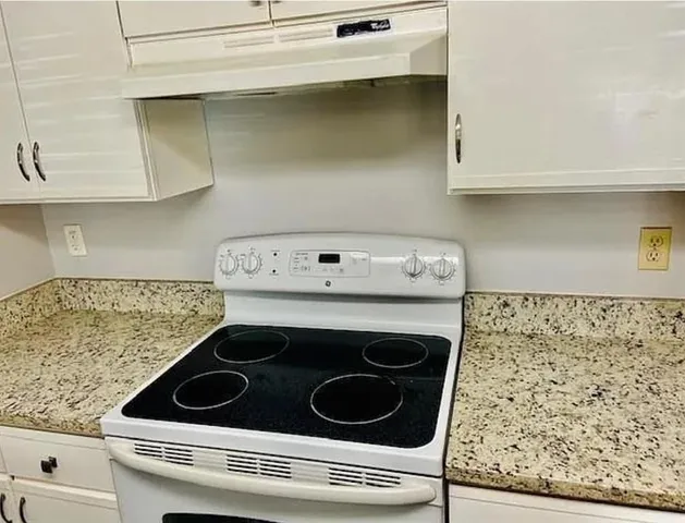 a stove top oven sitting inside of a kitchen