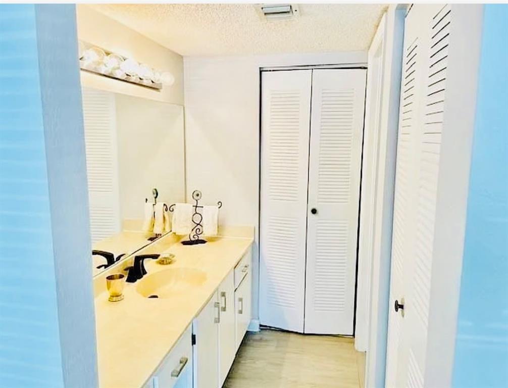 9733 Westview Drive, Unit 1314 Coral Springs, FL 33076 - Photo 8 of 15 a bathroom with a tub sink and mirror