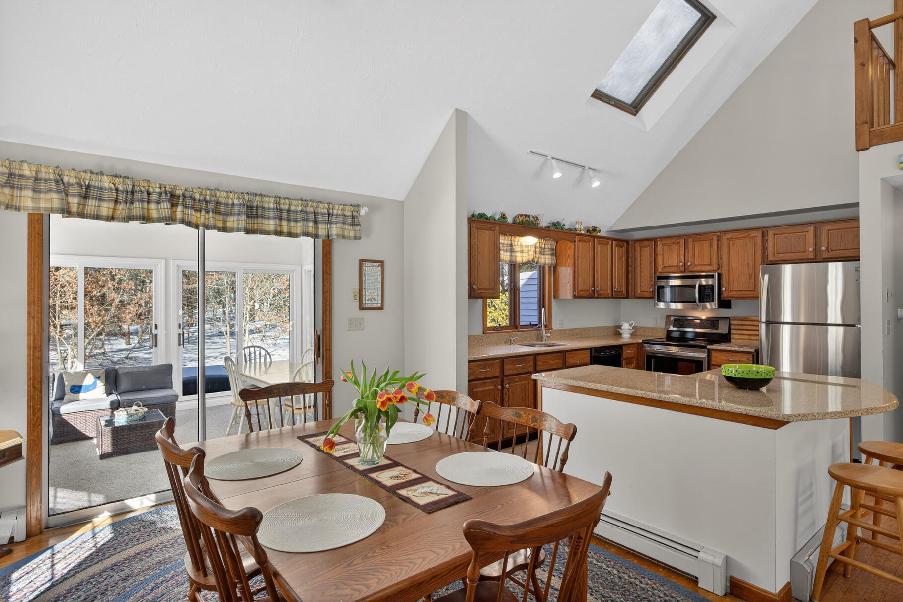 115 Wamsutta Road Eastham, MA 02642 - Photo 11 of 45 a kitchen with a table chairs stove and refrigerator