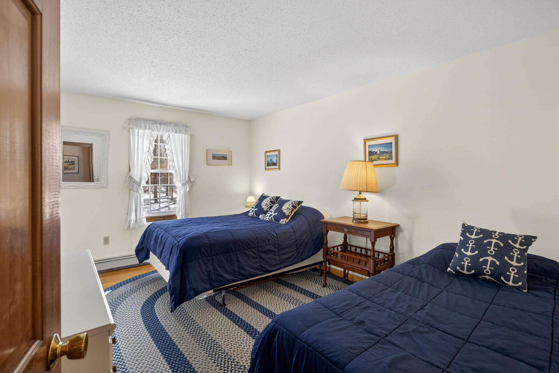 115 Wamsutta Road Eastham, MA 02642 - Photo 17 of 45 a bedroom with two beds and painted walls