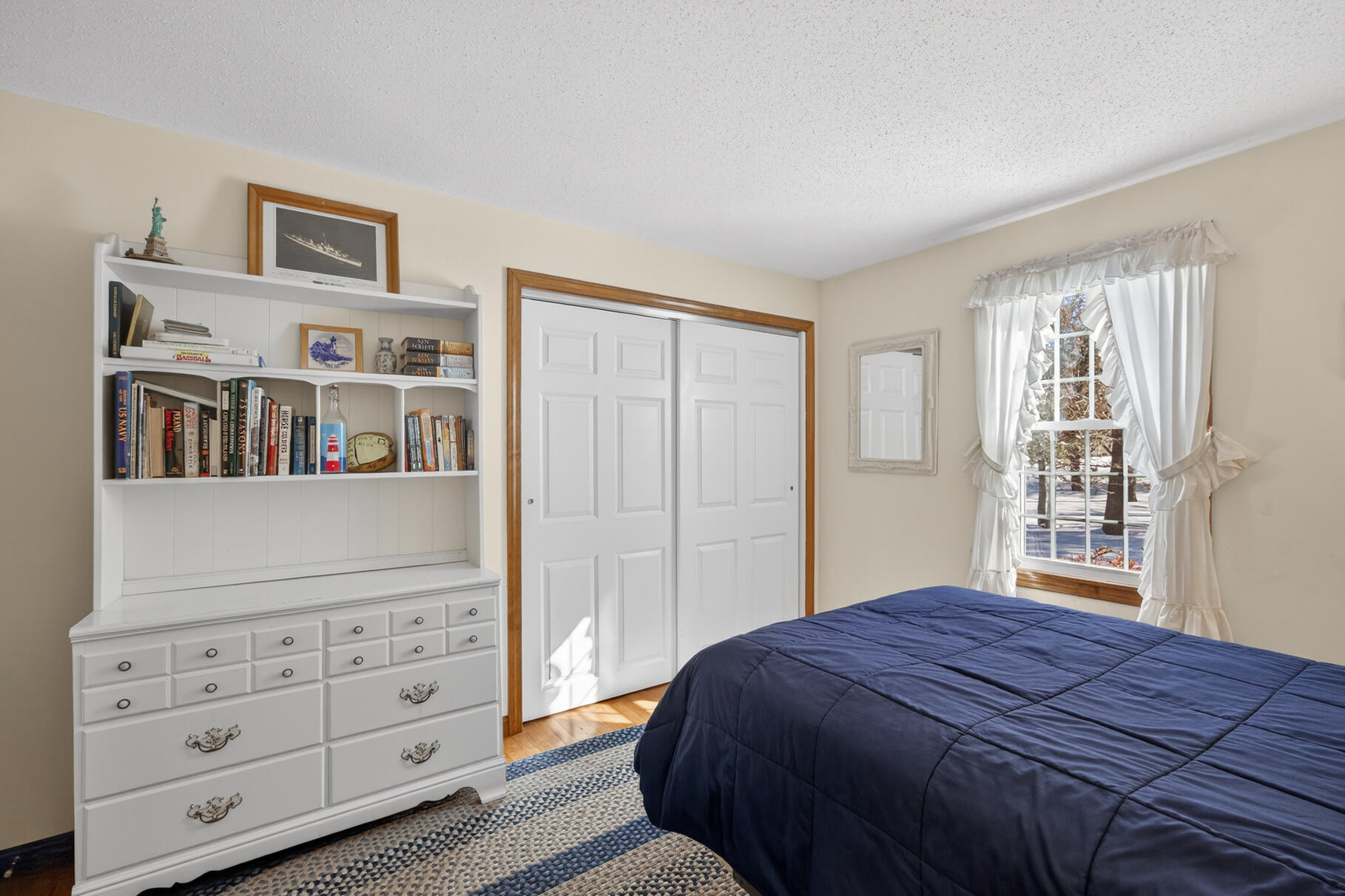 115 Wamsutta Road Eastham, MA 02642 - Photo 18 of 45 a bedroom with a bed a dresser and a window