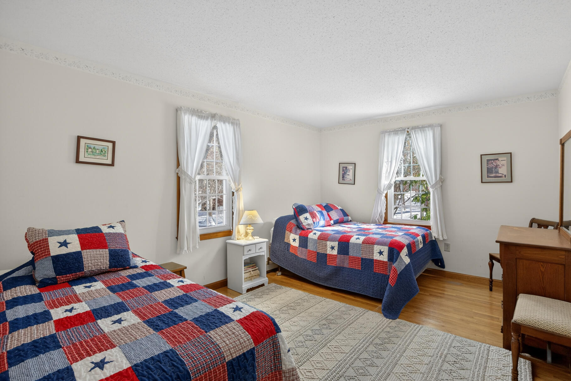 115 Wamsutta Road Eastham, MA 02642 - Photo 21 of 45 a bedroom with a bed and a dresser in it