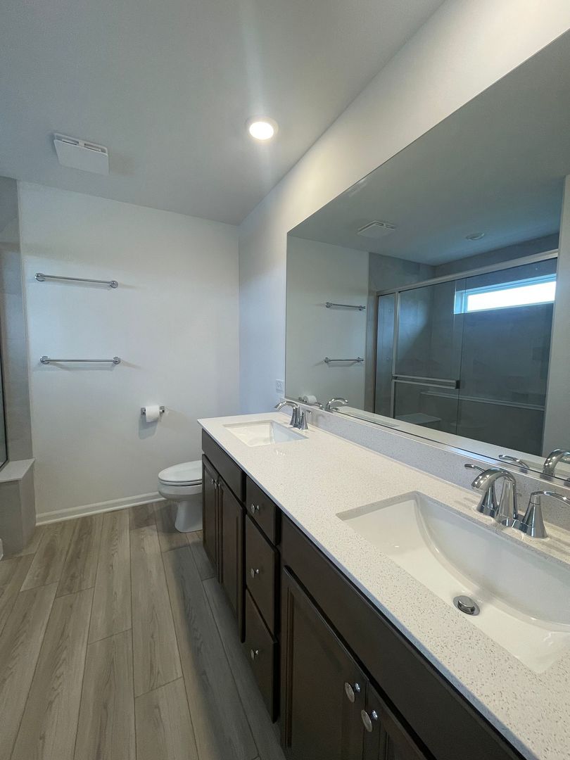 104 Henderson Street Oswego, IL 60543 - Photo 15 of 21 a bathroom with a sink and a mirror