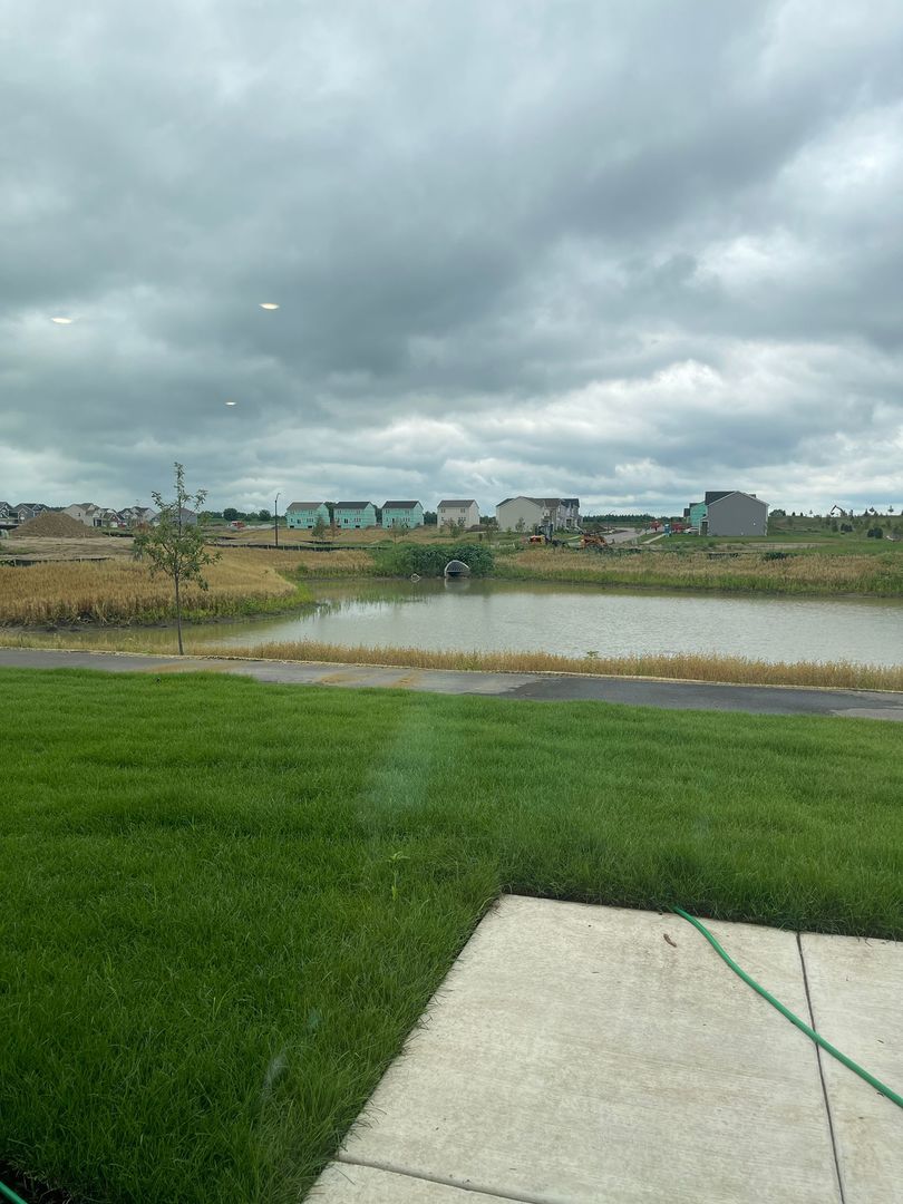 104 Henderson Street Oswego, IL 60543 - Photo 18 of 21 a view of a lake with a big yard