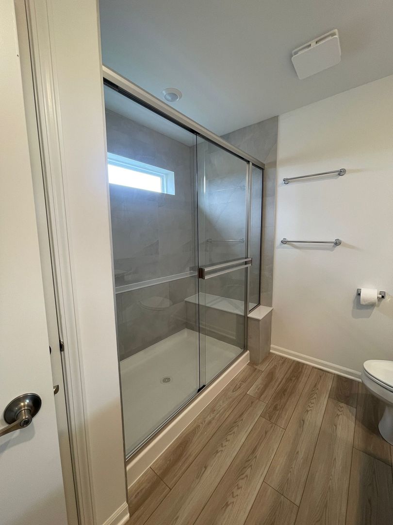 104 Henderson Street Oswego, IL 60543 - Photo 19 of 21 a bathroom with a granite countertop bathtub shower and toilet