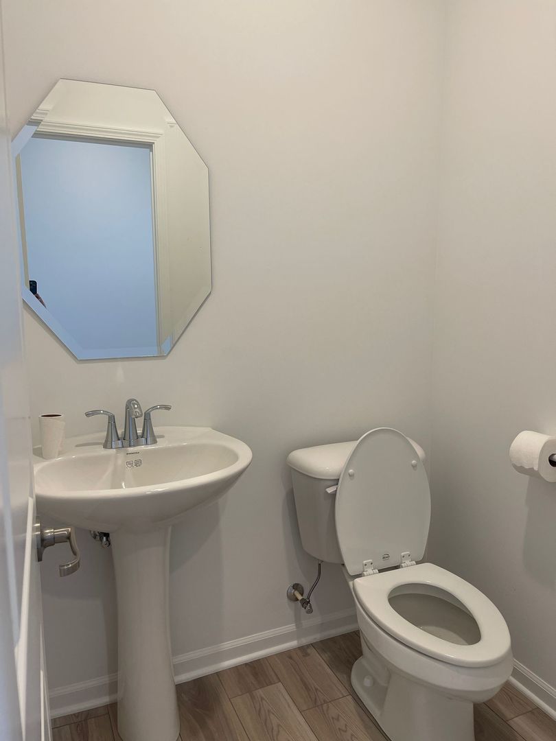 104 Henderson Street Oswego, IL 60543 - Photo 20 of 21 a bathroom with a toilet a sink and mirror