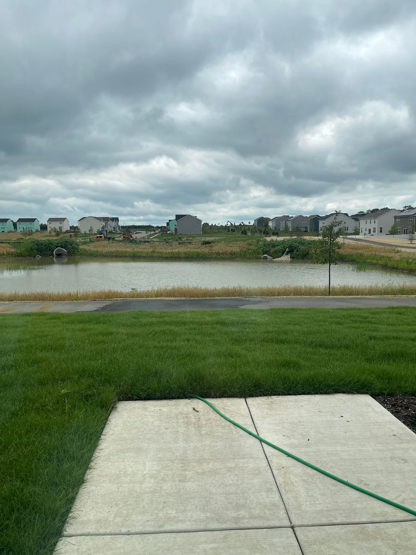 104 Henderson Street Oswego, IL 60543 - Photo 21 of 21 a view of a lake and a garden