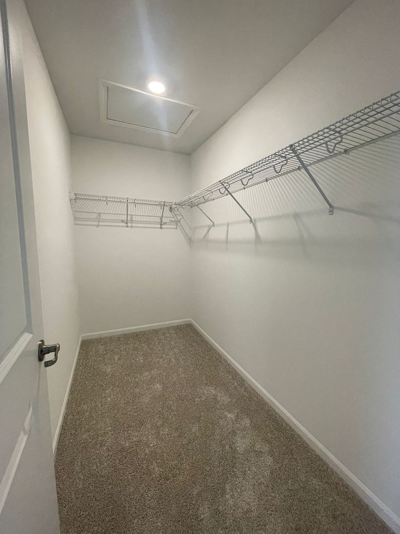 104 Henderson Street Oswego, IL 60543 - Photo 3 of 21 a view of a room with racks on the wall