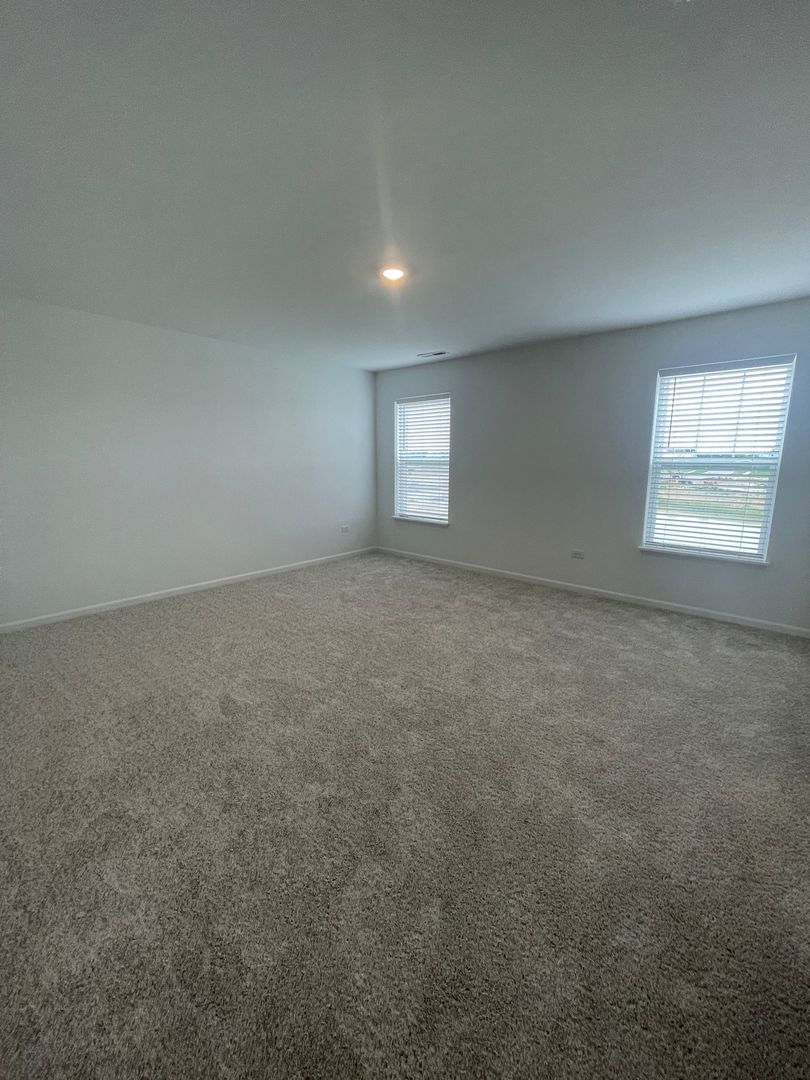 104 Henderson Street Oswego, IL 60543 - Photo 4 of 21 an empty room with a window