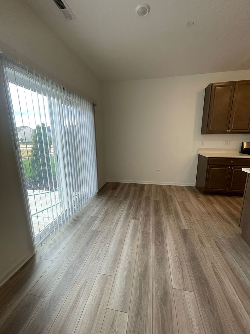 104 Henderson Street Oswego, IL 60543 - Photo 8 of 21 a view of a room with wooden floor and electronic appliances